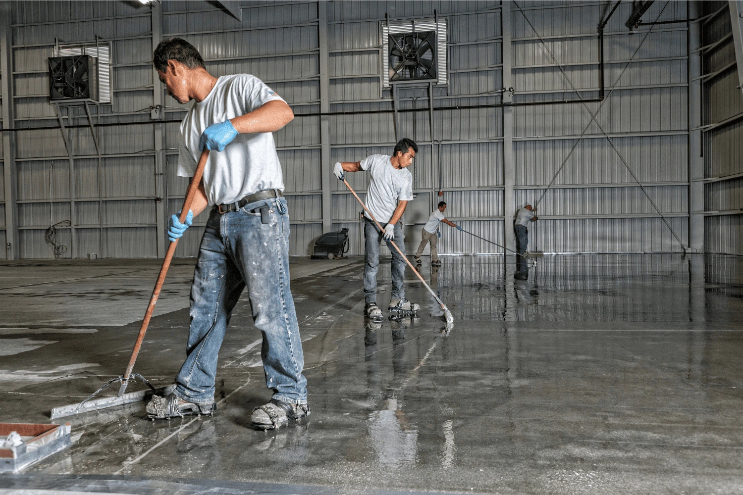 epoxy flooring and concrete coatings men putting down epoxy flooring