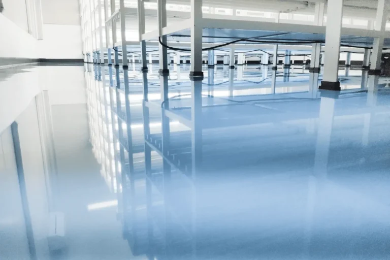 Seamless high-gloss epoxy floor in a clean industrial facility.