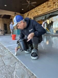 Epoxy flooring contractor cutting in the flooring. 