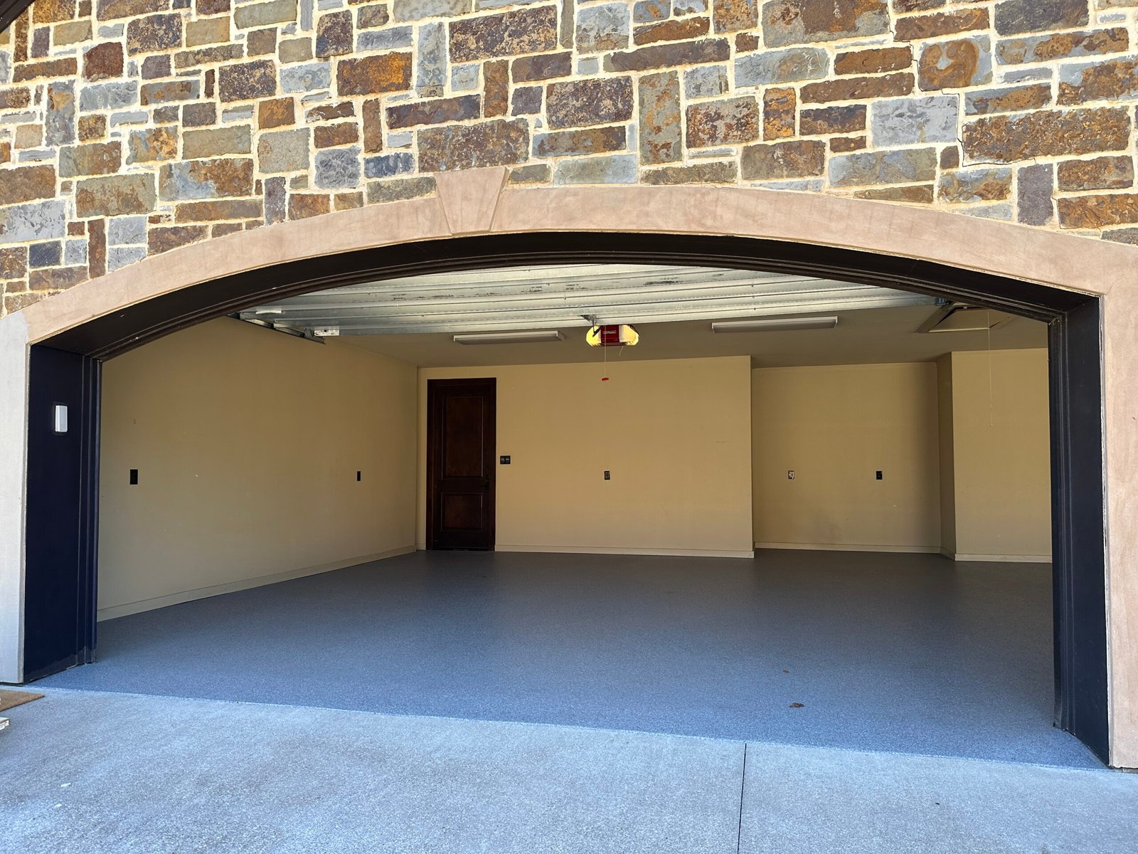 Garage with freshly coated polyaspartic flooring in East Texas, perfect for residential homes.