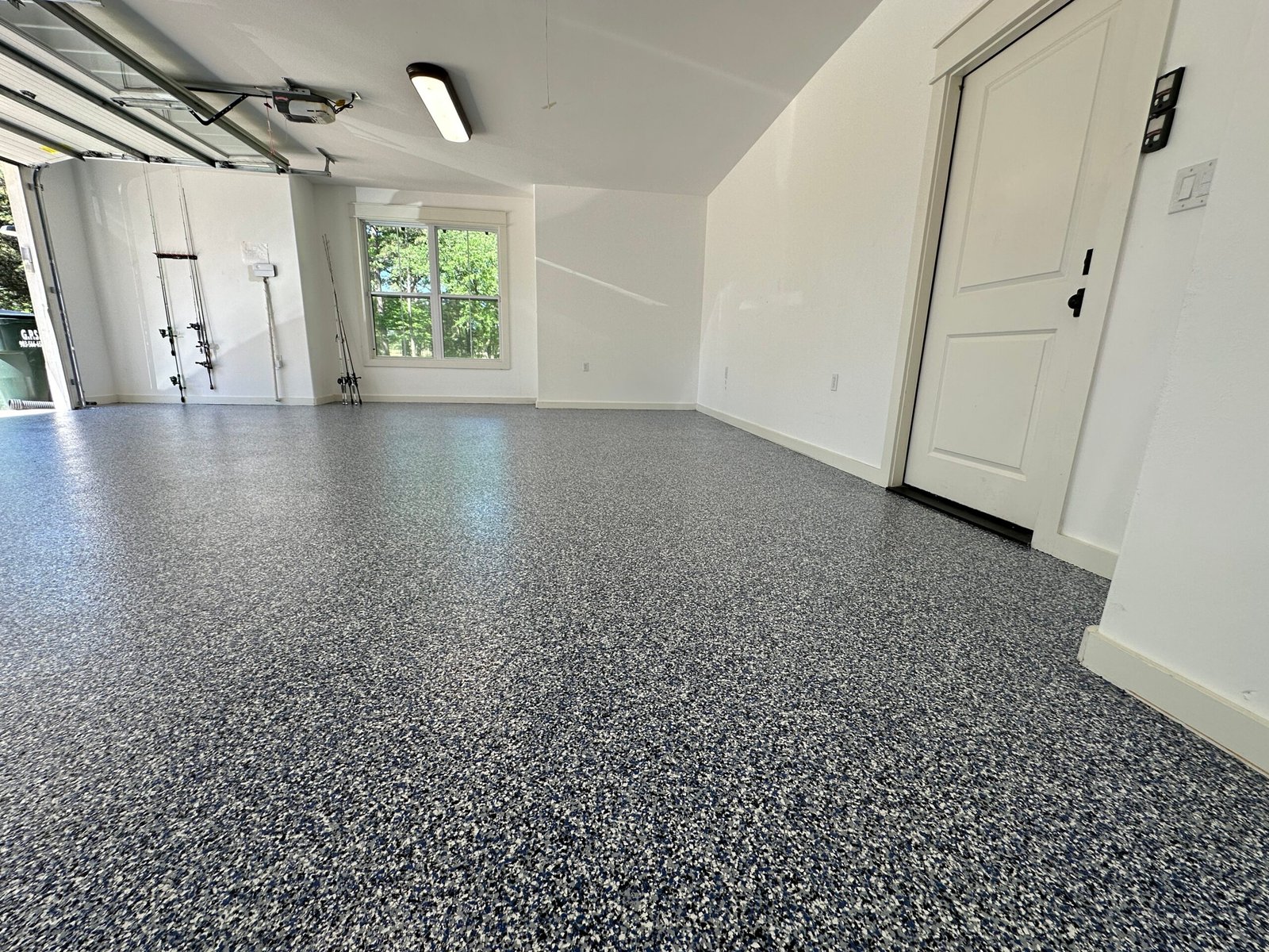 Blue and white polyaspartic garage floor installed in Whitehouse, Texas.