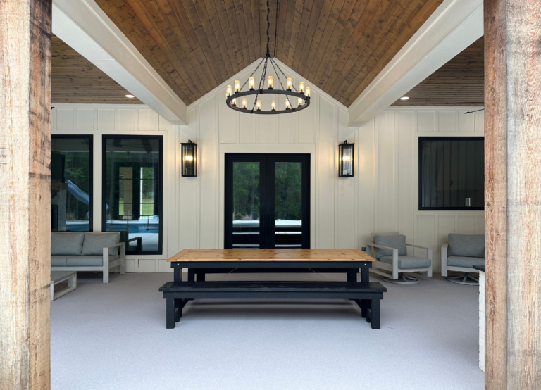 Outdoor dining area with chandelier and Oyster quartz floor under wood ceiling