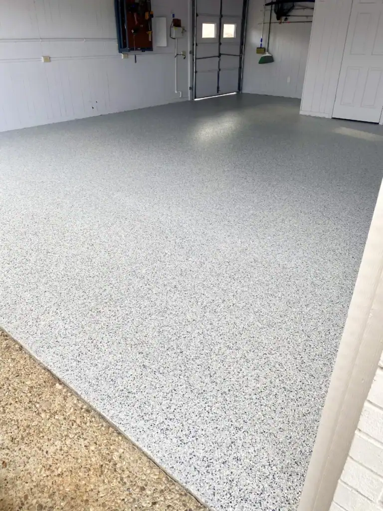 Durable epoxy coated garage floor with speckled finish for optimal performance.