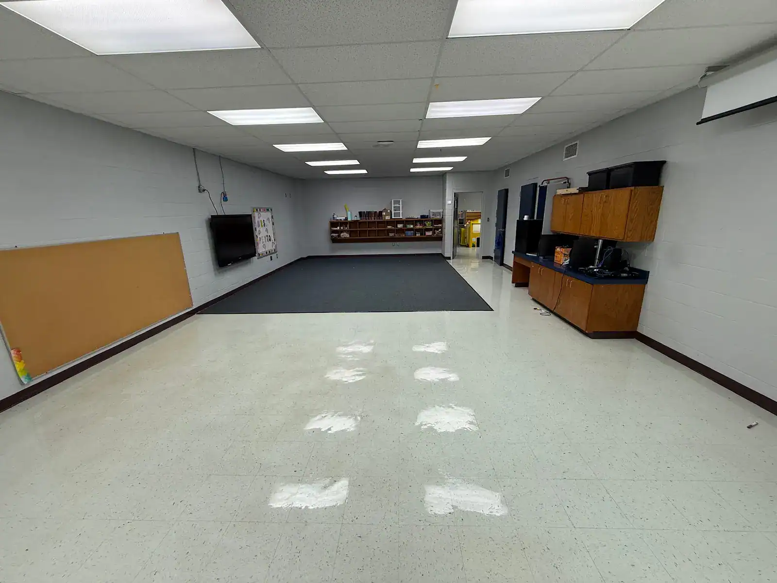 East Texas classroom with original flooring partially removed before coating