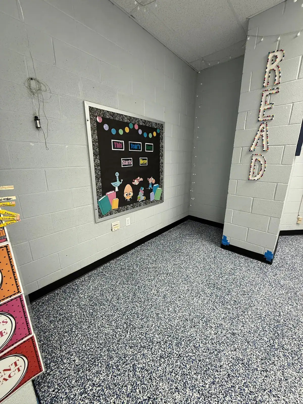 Custom blue white black and gray flake floor in an East Texas classroom