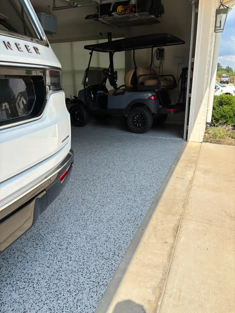 Finished Thunder flake flooring around vehicles in a Hideaway garage
