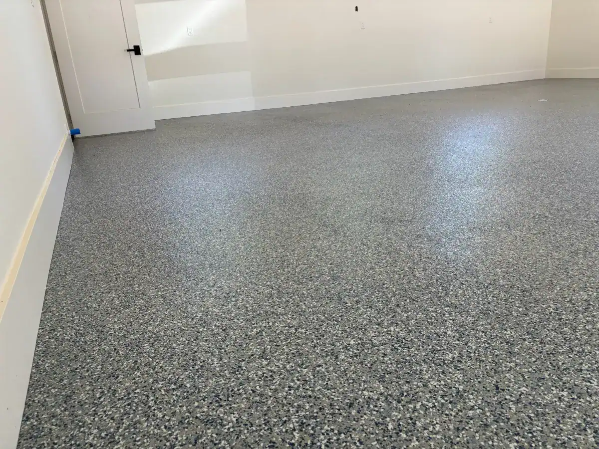 Custom flake floor extending from the main garage into an adjoining storage area.