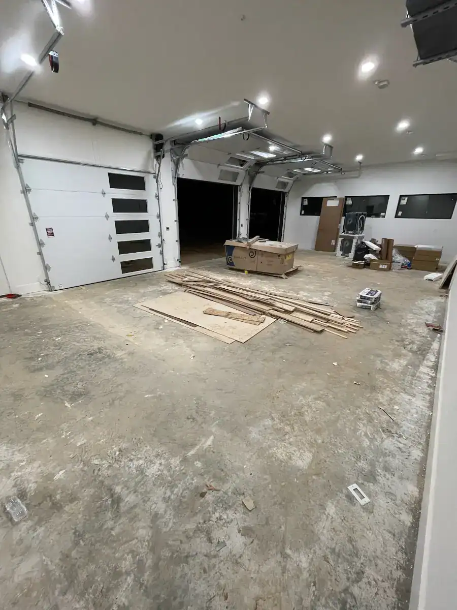 Large multi-bay lake house garage during construction before the floor coating installation.
