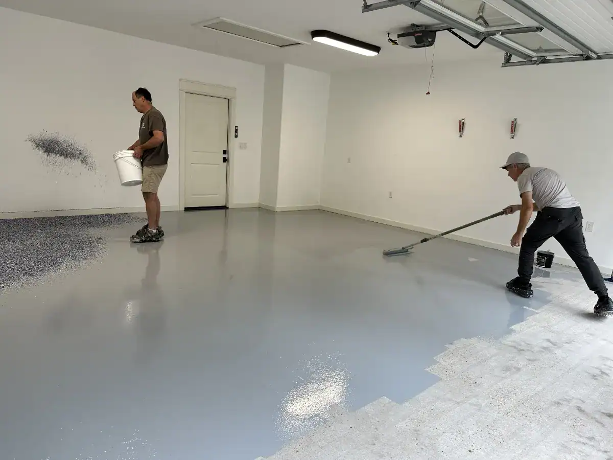 Epoxy Coat Masters crew applying the base coat to a prepared Lindale garage floor
